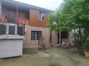 a brick house with a balcony and a patio at Private House in Batumi in Batumi