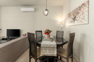 a dining room with a table and four chairs at Delis Villa in Kato Gouves