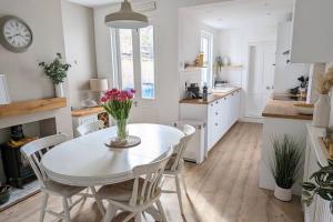 a kitchen with a table and chairs in a kitchen at Stunning Victorian Terrace in the Golden Triangle in Norwich