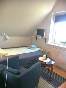 a bedroom with a bed and a table and a chair at NICE TOPFLOOR STUDIO APARTMENT in Copenhagen