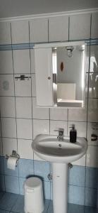 a bathroom with a sink and a toilet and a mirror at Windy Place in Fourfourás +48 photos
