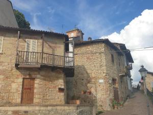 un bâtiment avec une tour d'horloge en haut dans l'établissement Location Turistic Antica dimora di Campagna Cir 00012, à Grazzano Badoglio