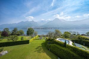 een tuin met uitzicht op een meer en de bergen bij Villa Costanza- private seasonal warm pool, steam room, sauna-Bellagio Village Residence in Oliveto Lario