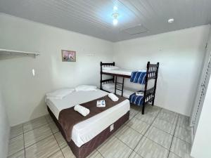 a bedroom with a bed and a desk in it at Parada do Parque Hotel in Penha