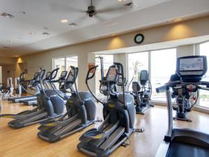 un gimnasio con una fila de máquinas de correr en una habitación en Portofino Island Resort #5-1102, en Pensacola Beach