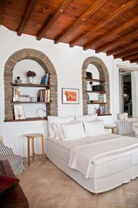 a bedroom with a large white bed in a room at Sea View Exclusive Studios - Tinos in Agios Ioannis