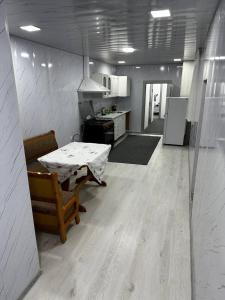 um quarto com uma cozinha com uma mesa e um frigorífico em ZARA Guest House em Bukhara