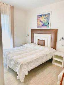 - une chambre avec un grand lit blanc dans l'établissement Park Hotel Cellini, à Lido di Jesolo