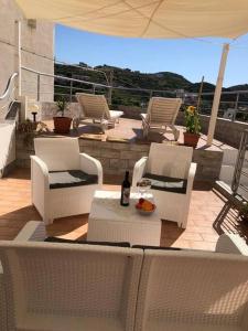a patio with chairs and a table with a bottle of wine at Casa Santa Maria - Suite Mediterraneo in Ponza