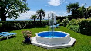 a fountain in the middle of a yard at Boutique Hotel Villa am See in Hagnau
