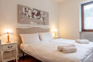 Postel nebo postele na pokoji v ubytování Residence Ledro