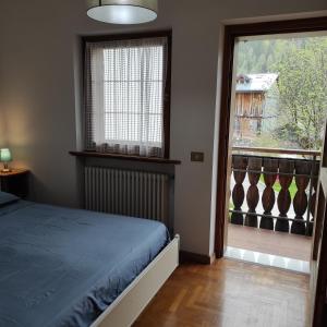 Postel nebo postele na pokoji v ubytování Casa San Valentino Dolomiti Val di Zoldo