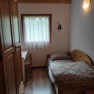 Postel nebo postele na pokoji v ubytování Casa San Valentino Dolomiti Val di Zoldo