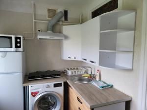 a small kitchen with a washing machine and a sink at SMILE in Ventspils