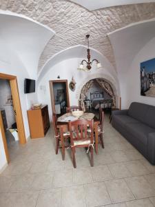 a living room with a table and a couch at Casa Vacanza Trullo Dimora Storica Morea in Alberobello