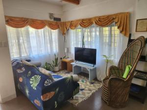 a living room with a couch and a flat screen tv at Viner's Inn in Tacloban