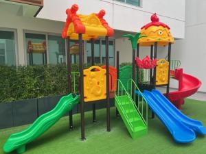 a childrens playground with a slide and a slideintend at New luxury apartment with king - size bed Ceibos in Guayaquil
