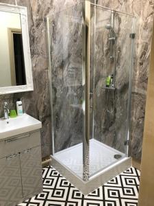 a bathroom with a shower with a glass door at The Forester and Flower in Bath