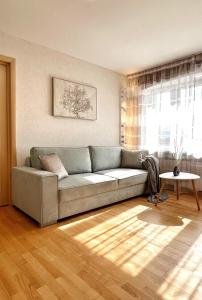 a living room with a couch and a table at New Apartment with a View in the Town Center in Narva