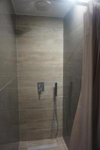 a bathroom with a shower with a shower curtain at Vasili's and Vasiliki's luxury apartment in Athens