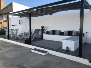 a pavilion with a couch and chairs on a patio at Casa Santo Antonio in Pias