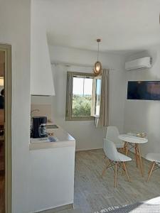 a kitchen and living room with a table and chairs at Eleonas 2 in Maragkas