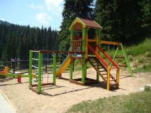 a playground with a slide in the sand at апартамент Крис 513 Stream tesort in Pamporovo