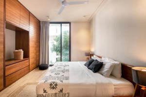 a bedroom with a large bed and a large window at Casa Libre - Awesome designer 3Br in Aldea Zama by StayPodio 306 in Tulum