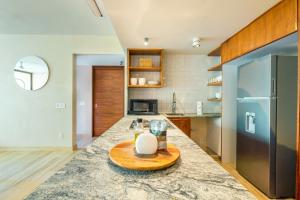 a kitchen with a table with a candle on a counter at Casa Libre - Awesome designer 3Br in Aldea Zama by StayPodio 306 in Tulum