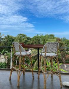 two chairs sitting on top of a balcony at Habibi Hostel & Restaurant in Unawatuna
