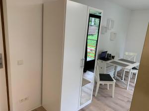 a mirror in a room with a table and a chair at Kleines Einzimmer-Apartment 14 in Bad Wildbad