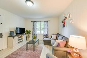 a living room with a couch and a tv at Winston-Salem Vacation Rental about 3 Mi to Downtown! in Winston-Salem