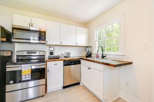 a kitchen with white cabinets and stainless steel appliances at Winston-Salem Vacation Rental about 3 Mi to Downtown! in Winston-Salem