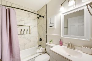 a bathroom with a pink shower curtain and a sink at Winston-Salem Vacation Rental about 3 Mi to Downtown! in Winston-Salem +19 photos
