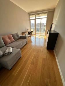 a living room with a couch and a television at Gem in the Heart of Yerevan in Yerevan