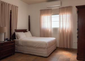 1 dormitorio con cama y ventana en Turtle Bay Inn, en Lajas