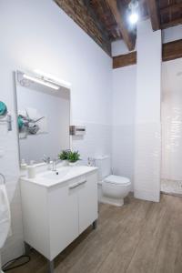 a white bathroom with a sink and a toilet at Cozy Duplex Apartment 1 step to City Center SelfCheckin! in Valencia