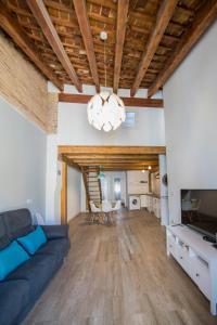 a living room with a blue couch and a table at Cozy Duplex Apartment 1 step to City Center SelfCheckin! in Valencia