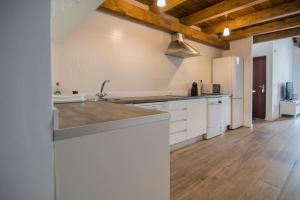 a kitchen with white appliances and a wooden ceiling at Cozy Duplex Apartment 1 step to City Center SelfCheckin! in Valencia