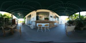 a restaurant with a bar and tables and chairs at Turtle Bay Inn in Lajas