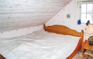 uma cama num quarto com uma parede de madeira em Stunning Home In Frde I Hordaland With Kitchen em Førde