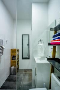 a bathroom with a sink and a mirror at Trankilidad Apartments in Santa Cruz