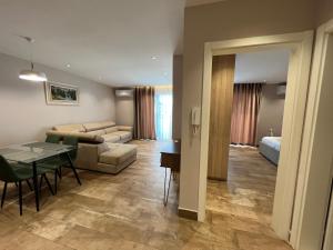 a living room with a couch and a table at Armando Apartments in Golem +75 photos