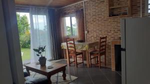 a kitchen with a table and chairs and a dining room at Leu Océans in Saint-Leu