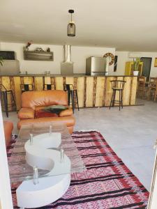 a living room with a couch and a table at Chambres hôtes de la Motte-Fanjas in La Motte-Fanjas