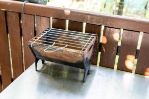 a bird cage sitting on top of a wooden bench at Casas Casal Do Carvalhal - Agroturismo in Amares
