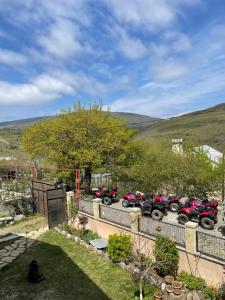 a group of motorcycles parked in a parking lot at Guest House Shtili in Prezeti