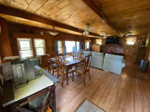a dining room with a table and chairs at Adirondack Waterfront Cabin Upper Hudson Tributary in Lake Luzerne