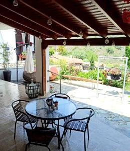 a patio with a table and chairs on a patio at BELLE VUE Mountain Home in Kalopanayiotis