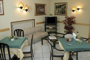 a living room with two tables and a couch at Lago Maggiore in Lesa